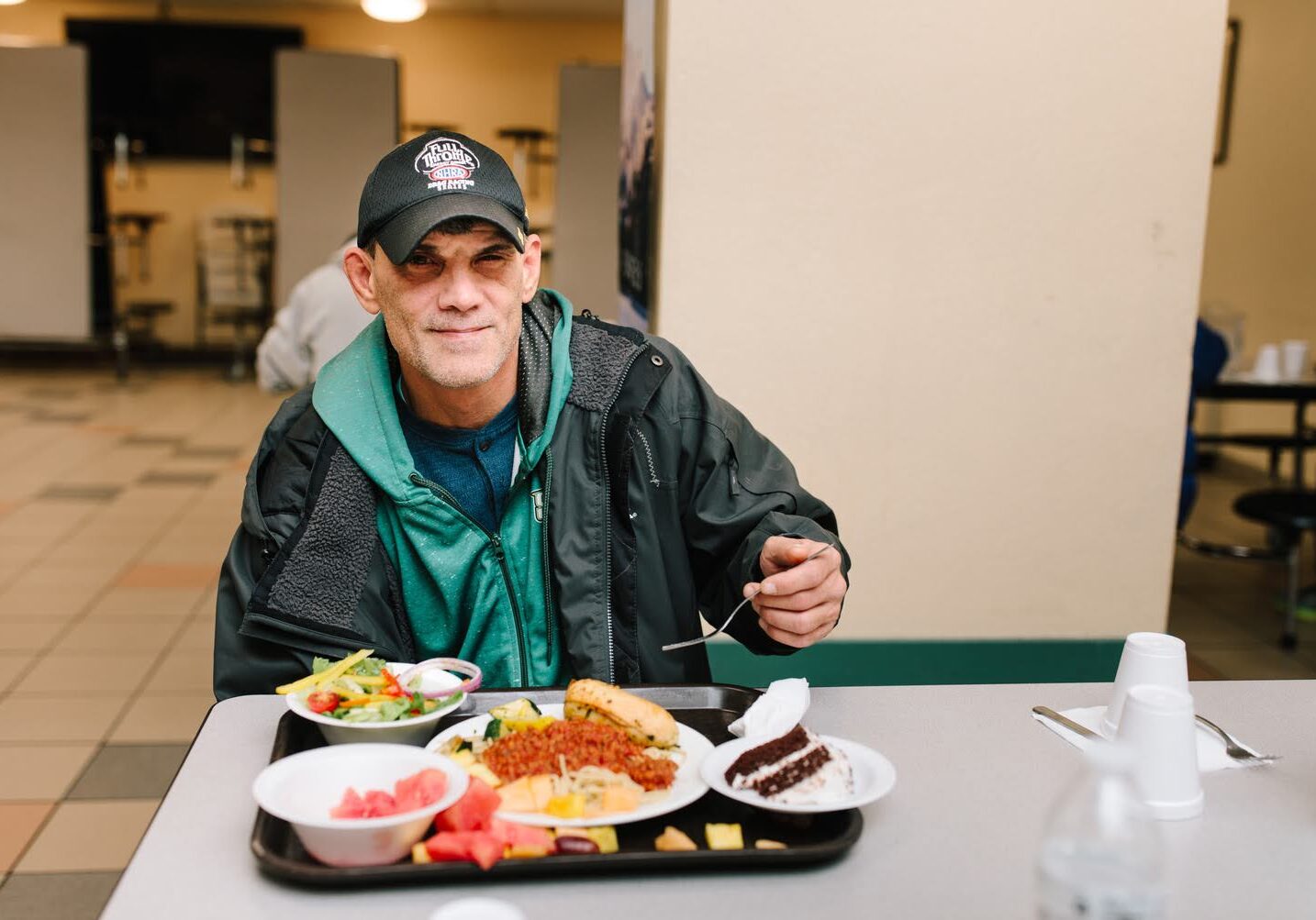 David seated with a meal at the Mission