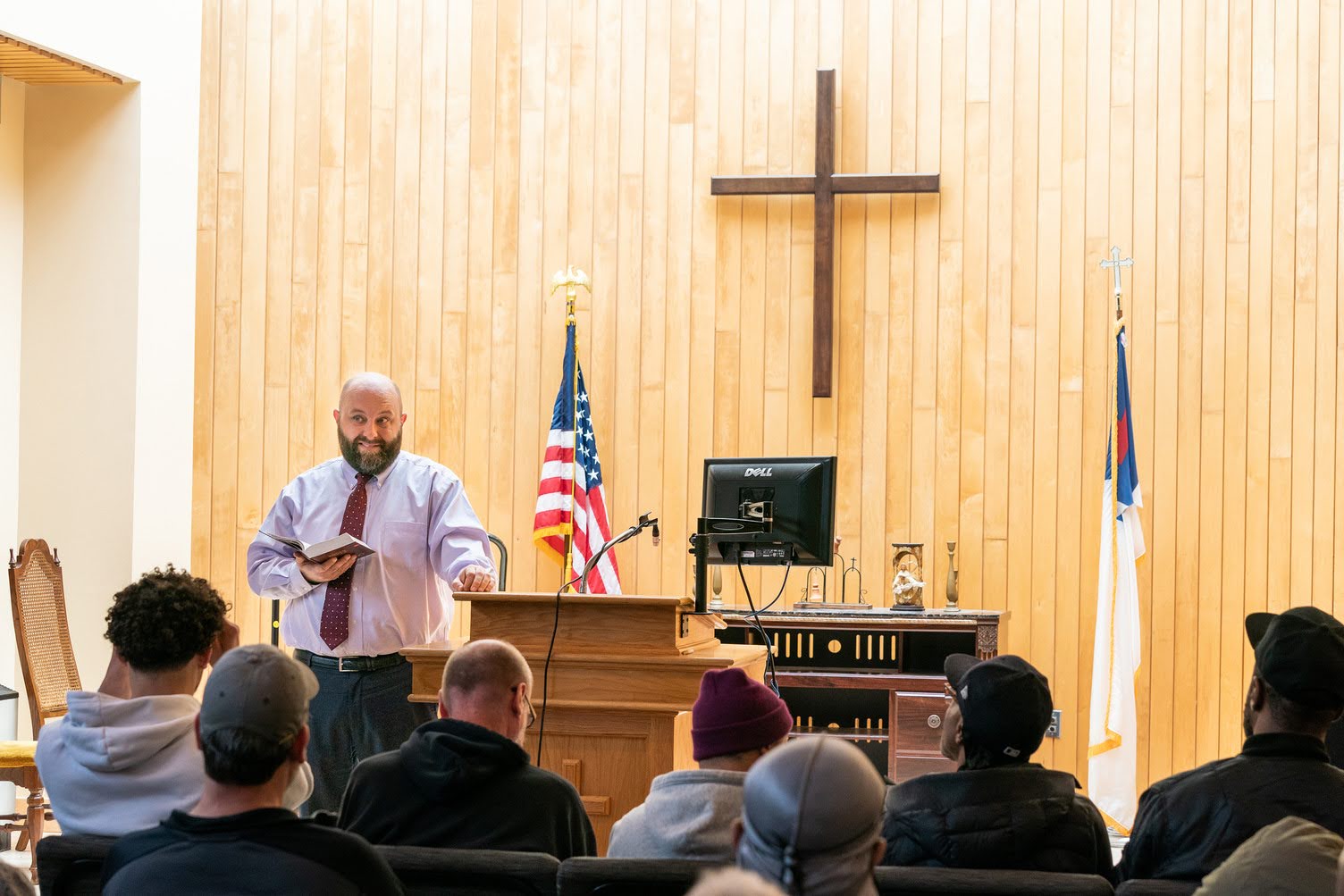 Pastor speaking from the Capital City Rescue Mission chapel pulpit