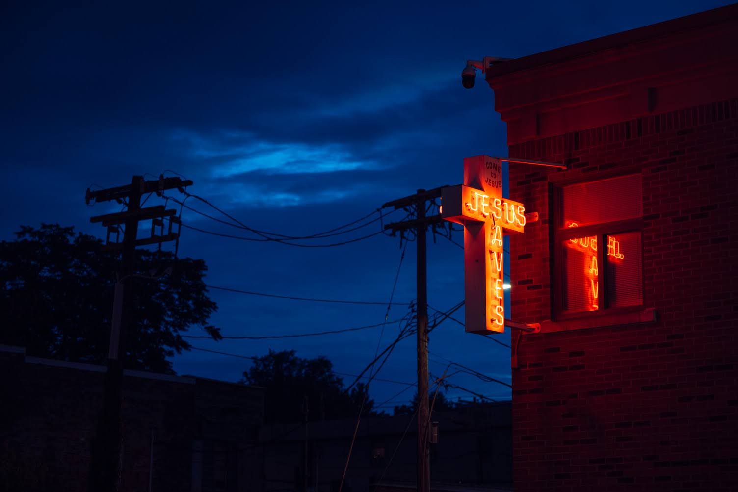 Illuminated Jesus sign on a church building at night