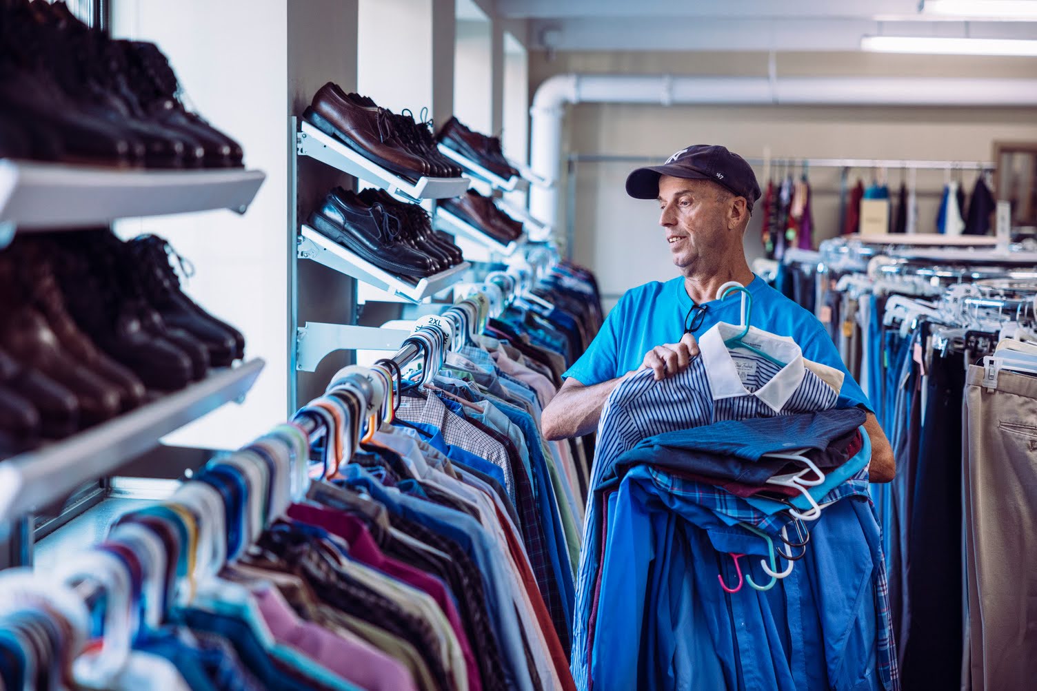 Clothing center staff member organizing donated clothes