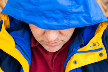 Guest bundled in a blue and yellow winter coat