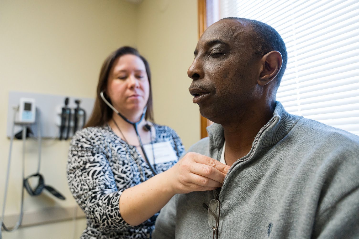 A medical volunteer checking a guest with a stethoscope