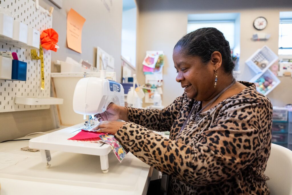 Cristeen working at a sewing machine