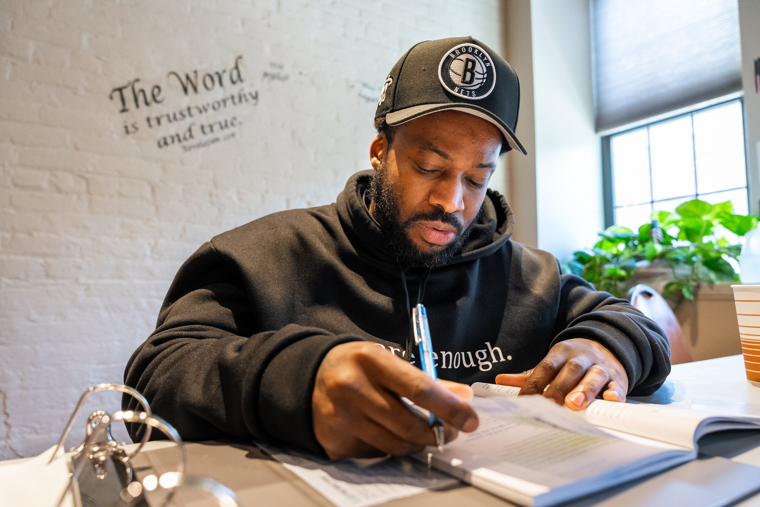 A program participant writing at a desk